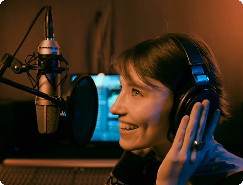 A radio host wearing headphones speaking into a studio microphone